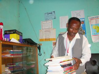 Head Teacher recieving books from Link Ethiopia